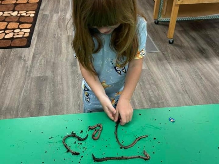 girl playing with worms